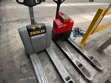 a forklift that is sitting on the ground in a warehouse