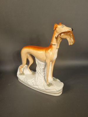 a figurine of a dog that is standing on a table