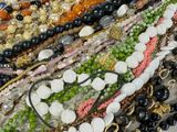 many different types of beaded necklaces and bracelets