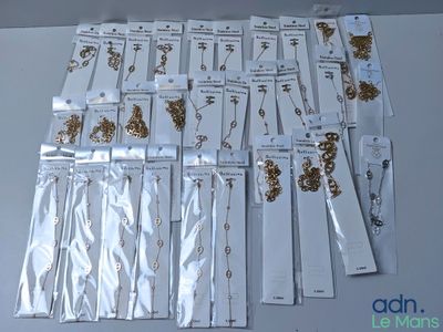 a lot of gold and silver necklaces on a table