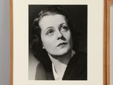 two framed black and white photos of a woman in a suit and tie