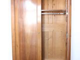 a wooden armoire with a door and a shelf
