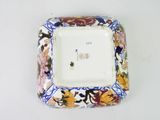 a small square plate with a floral design on it