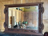 a mirror that is on a mantle in a room