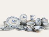 a pile of blue and white plates and bowls