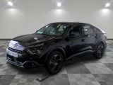the black suv is parked in a large room with a checkered floor