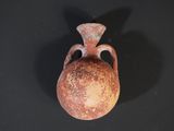 a small vase that is sitting on a black surface