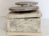 two marble coasters stacked on top of each other on a white surface