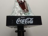 a coca cola bottle on top of a table