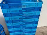 a stack of blue plastic crates sitting next to each other