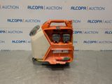 a close up of an orange and white machine on a table