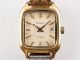 a close up of a wrist watch on a white surface