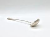 silver spoon on a white surface with a small spoon sticking out of it