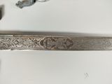 an image of a silver spoon with a handle and a spoon rest on top of it