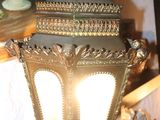 a lamp that is sitting on a table in front of a painting