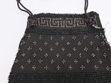 an image of a black beaded purse on a white surface