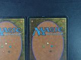 two decks of magic the gathering cards on a black table
