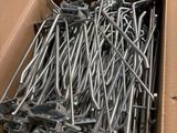 a box full of nails in a box on the floor