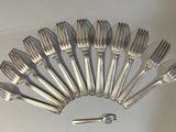 a lot of forks and spoons arranged in a circle