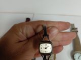 a person that is holding a watch in their hand
