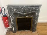 a fire place with a fire extinguisor and a fire extinguisor next to it