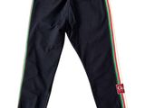 a close up of a black pants with a red, green, and yellow stripe