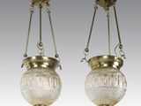 a pair of antique brass and glass hanging lamps