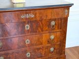 a dresser with a lamp on top of it in a room