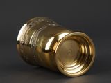 an image of a close up of a gold cup on a black surface