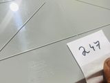 a person holding a piece of paper that has been cut in half