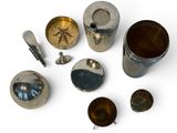 a lot of silver objects that are on a white surface