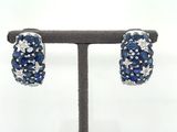 pair of blue sapphire and diamond earrings on display on a stand