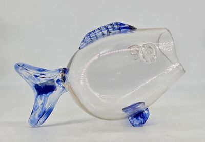 a glass fish figurine with a blue and white design