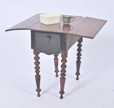 a small table with a cup on top of it