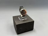 an image of a watch on a stand on a white surface