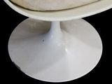 a pizza on a white plate on a white pedestal