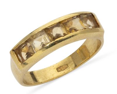 a close up of a yellow gold ring with square cut stones