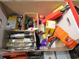 a cardboard box filled with assorted items on the floor
