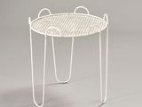 a white table with a basket on top of it