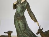 statue of a woman with two deer and a goat on a marble base