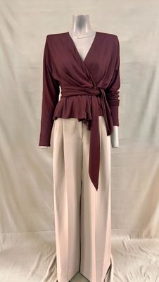 an image of a mannequin mannequin wearing a maroon top and beige pants