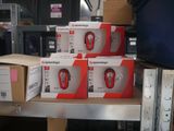 several boxes of nintendo wii remotes on a shelf in a warehouse
