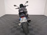 a motorcycle that is parked in a room with a checkered floor