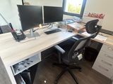 a desk with two monitors and a laptop on it