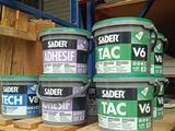 many cans of paint sitting on a shelf in a warehouse