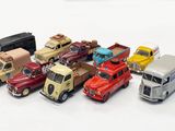 many toy cars that are lined up together on the table