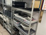 many shelves with dishes and pans on them in the kitchen