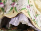 a figurine of a woman in a dress with flowers on it