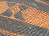 a close up of a woven basket with a bird on it