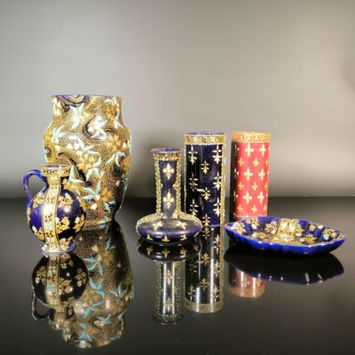 three vases and a plate on a table
